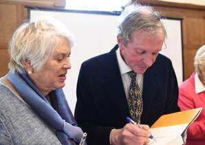 Rupert Sheldrake signing a copy of his book
